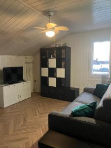 a living room with a couch and a flat screen tv at Casa Lanza in Chioggia