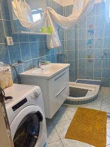 a bathroom with a washing machine and a sink at Daniela in Vir