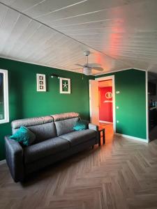 a living room with a couch and a red door at Casa Lanza in Chioggia