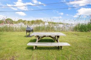 two picnic tables sitting in a field of grass at Dockside 2BR - Marina - Dining - Charter Access Unit A in Montauk