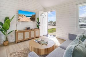 a living room with a couch and a table at Dockside 2BR - Marina - Dining - Charter Access Unit A in Montauk