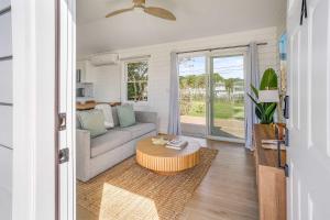 a living room with a couch and a coffee table at Dockside 2BR - Marina - Dining - Charter Access Unit A in Montauk +18 photos