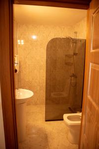 a bathroom with a shower and a toilet and a sink at THE SANDHİLl OTEL RESTAURANT in Kemer +213 photos