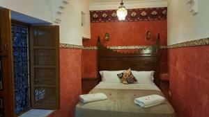 Postel nebo postele na pokoji v ubytování RIAD DAR En-Nawat