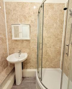 a bathroom with a sink and a shower at Flat In Stokes Croft in Bristol +8 photos
