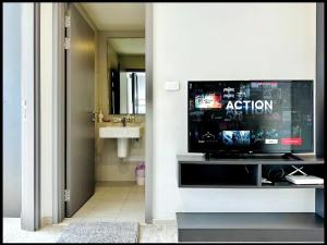 a bathroom with a tv and a bathroom with a bathroom at Great Location - Awesome Pool in Pattaya Central
