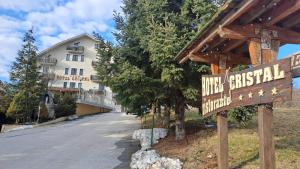a sign for a hotel in front of a building at Hotel Cristal in Roccaraso