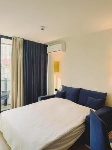 a bedroom with a bed and a window at Sea View Apartment in Batumi