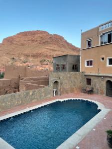 a large pool of water in front of a building at Les Jardins De Todgha gorges de todra tinghir in Aït Baha
