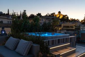 a jacuzzi tub on the roof of a building at Meros - Athenian Residencies in Athens