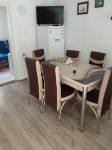 a dining room table with chairs around it at seosko turisticko gazdistvo milanovic zuc in Žuč +18 photos