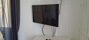 a flat screen tv hanging on a wall at By The Bay Oracabessa Queen Bedroom Suite in Oracabessa