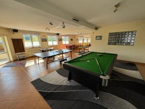 a living room with two tables and a pool table at Willa Góry A - Noclegi z widokiem na góry śniadaniami i sauna in Bukowina Tatrzańska
