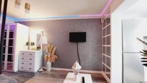 a living room with a tv on a wall at Excelsior Deluxe in Piteşti