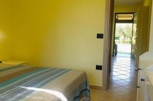 a bedroom with a bed and a door to a patio at Hotel Residence Il Rifugio in Palinuro