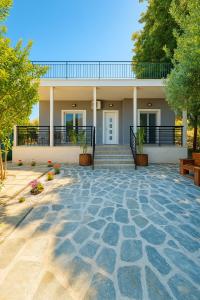 a house with a stone patio in front of it at House 2BD Private Parking Next to Center in Asprovalta