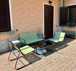 two chairs and a table on a patio at Appartamenti Sole e Lago in Gravedona