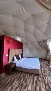 a bedroom with a large bed in a tent at environment wadi rum in Wadi Rum