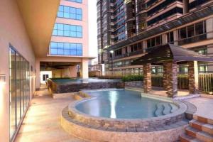 a swimming pool in the middle of a building at Grand Riviera Condotel Near St lukes Medical Center in Manila