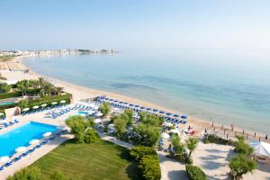 an aerial view of a beach with umbrellas and a resort at Hotel Sierra Silvana in Selva di Fasano