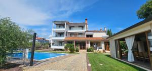 a house with a swimming pool next to a house at AURA Residence in Rovinj