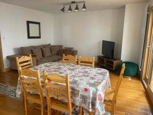 a living room with a table and chairs and a couch at La belle Échappée in Planay