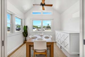 a dining room with a table and a ceiling fan at Dockside 2BR - Prime Location on the Marina Unit B in Montauk