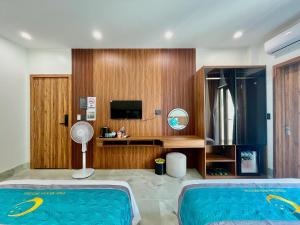 a hotel room with a swimming pool and a tv at The Moon Hotel in Quảng Trach