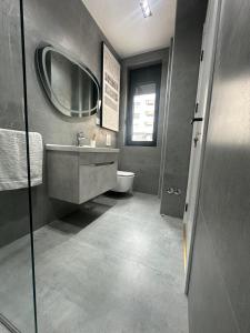 a bathroom with a sink and a mirror at Bahr DELUX App & Suite in Ulcinj