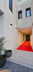 a red carpet in the hallway of a building at Bahr DELUX App & Suite in Ulcinj