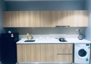 a kitchen with a sink and a washing machine at Vintage Homes at i-City - WiFi TV Box 1 Carpark in Shah Alam