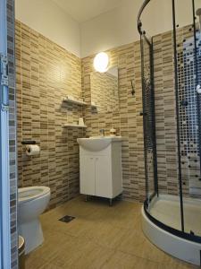 a bathroom with a toilet and a sink and a shower at Casa Adrian in Corbu +36 photos