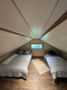 a room with two beds in a tent at More Holiday Pine House in Bigauņciems