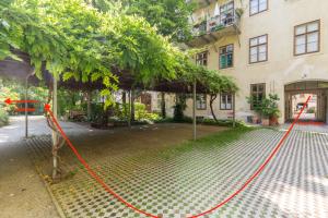 a building with orange rope around a tree at XXXl bed/ free parking/ central in Vienna