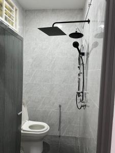 a bathroom with a shower and a toilet at Nurul Ain Homestay, Nearby Kelulut Beach, Marang in Marang +12 photos