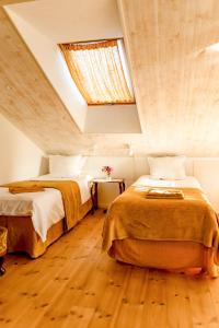 two beds in a room with a skylight at Blomstertantens Hus in Trelleborg +30 photos