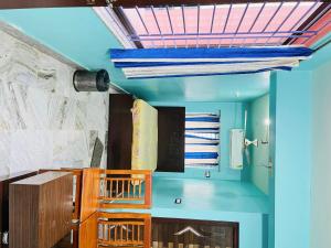 a room with blue walls and a blue ceiling at hOTEL LAVANYA in Tamlūk