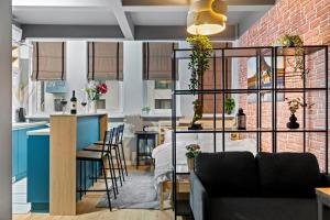 a living room and kitchen with a brick wall at Old Town Smârdan Studios - Central Lively Area in Bucharest