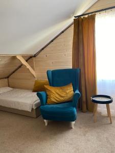 a bedroom with a bed and a blue chair at Villa SPA  +21 photos
