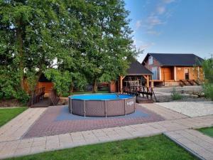 a pool in the middle of a yard with a house at Villa SPA in Czerwona Góra