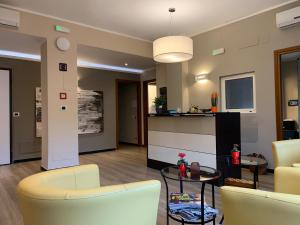 a living room with two chairs and a table at St Martin House in Genoa