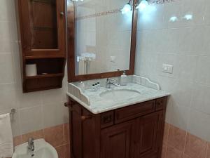 a bathroom with a sink and a mirror and a toilet at Le Terrazze di katia rooms in Riomaggiore