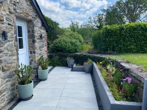 a garden with potted plants next to a building at Garth Engan Private Self Contained B&B with Garden Area in Llanbedr