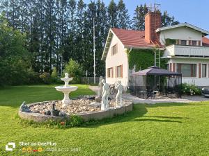 a fountain in a yard in front of a house at Nina`s GuestHouse, Jämsä City, 160 m2, Include x2 Himos Ski Pass in Jämsä