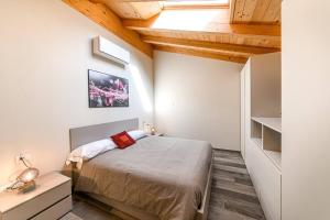 a bedroom with a bed in a room with wooden ceilings at Residenza Cavour - Appartamento C in Tirano