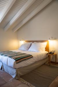 a bedroom with a bed with white sheets and pillows at Herdade do Carregouçal in Odemira +87 photos