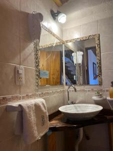a bathroom with a sink and a mirror at Cabañas El Legado in Los Molles +83 photos