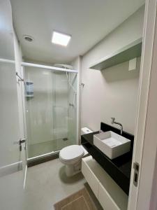 a bathroom with a shower and a toilet and a sink at Studio Cute, Parque Una in Pelotas