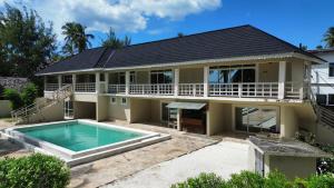 an image of a house with a swimming pool at Kikoi Boutique Hotel in Michamvi