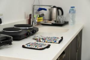 a kitchen counter with two utensils on a counter top at بفن للشقق المخدومة Puffin Serviced Apartments in Al Jubail